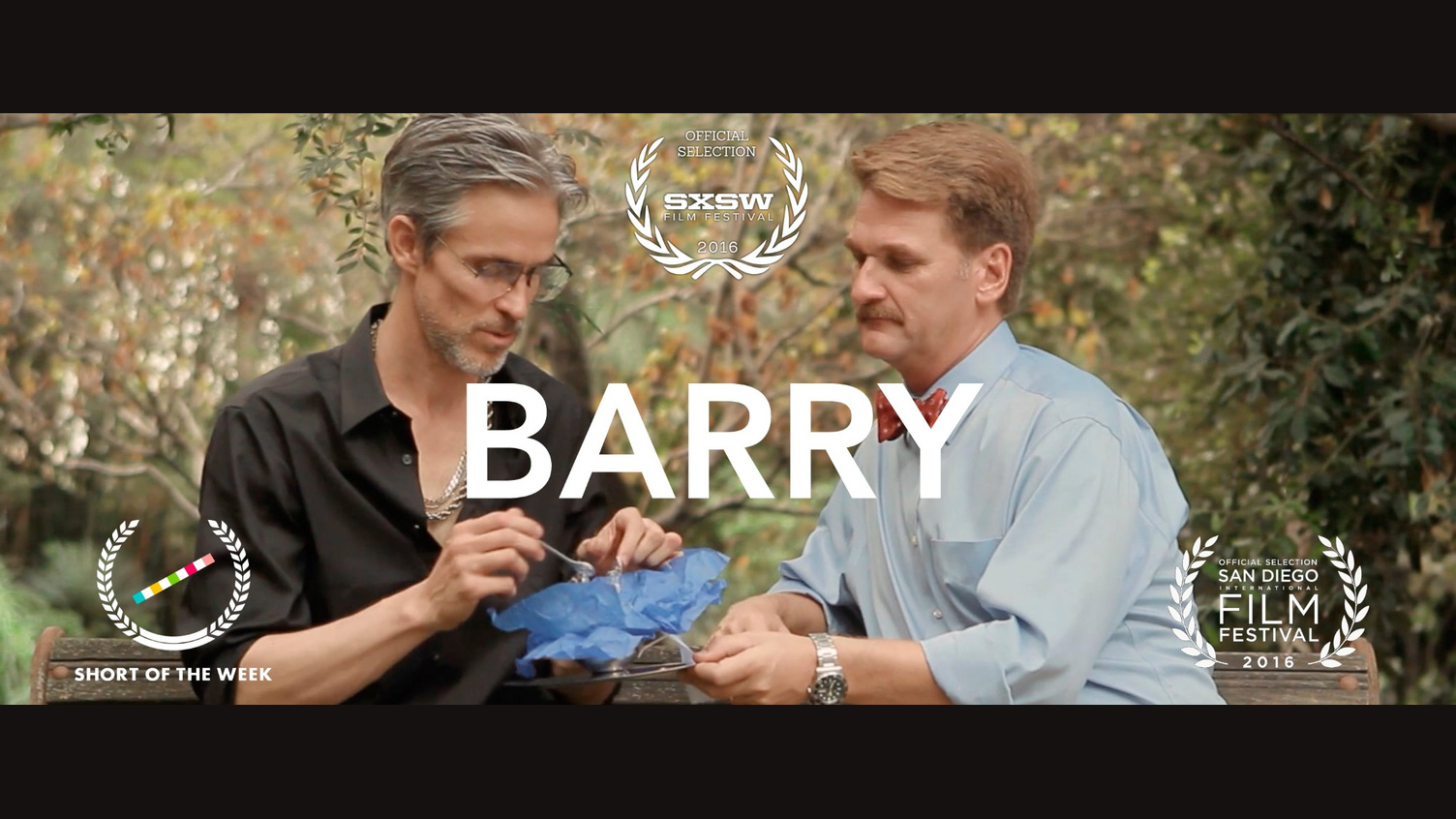 Two men outdoors in a still from Barry, with title and festival laurels